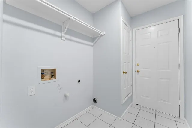 an empty room with chandelier fan and windows