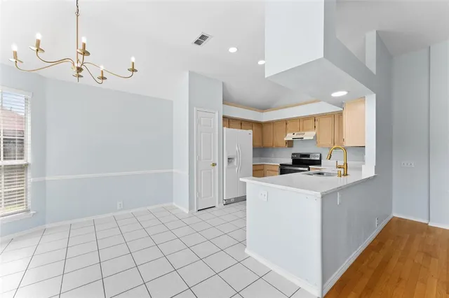 a kitchen with stainless steel appliances a stove top oven and cabinets