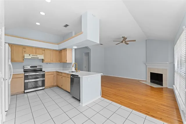 a kitchen with a stove sink and cabinets