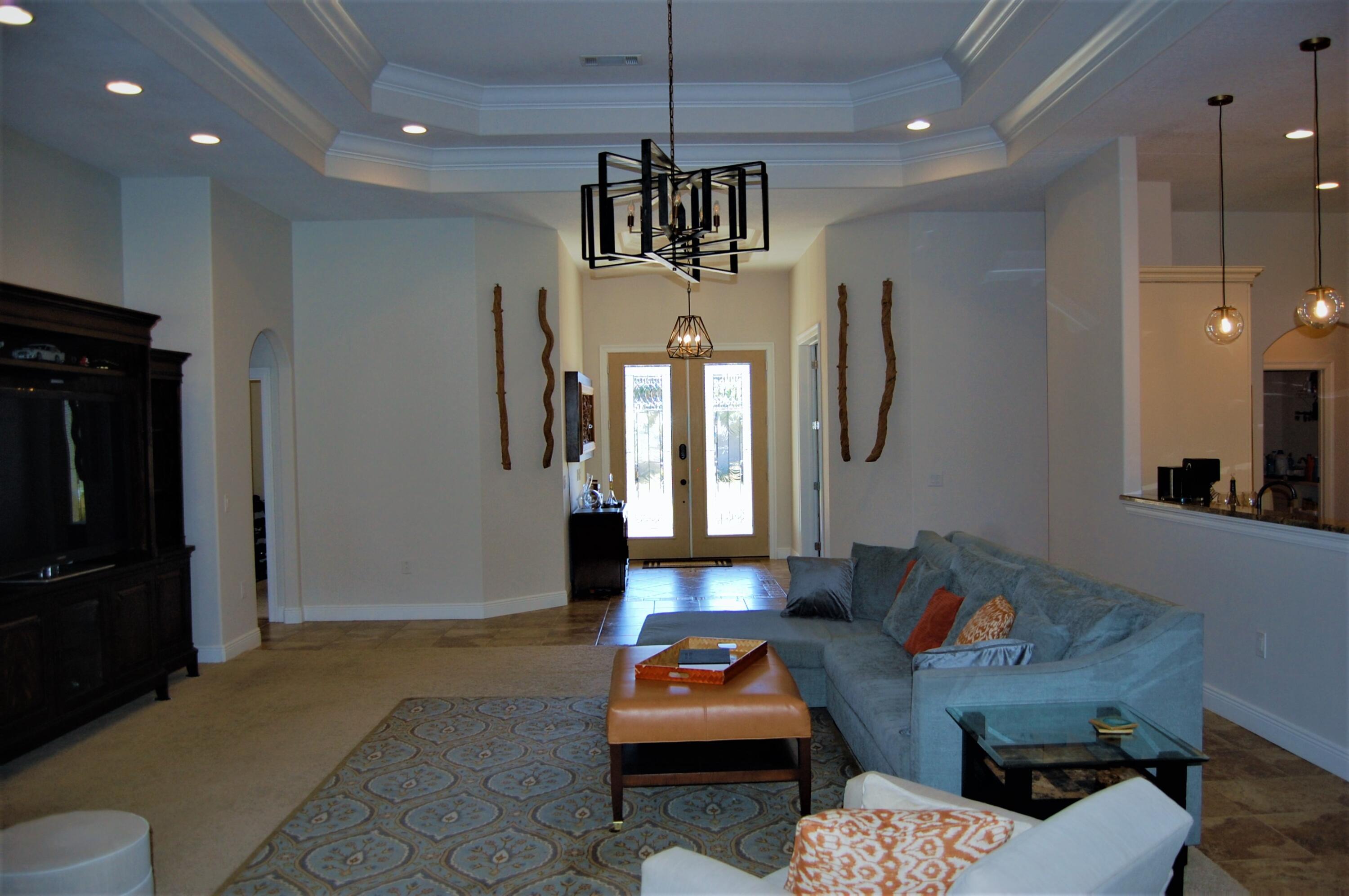 2497 Crescent Road Navarre, FL 32566 - Photo 17 of 51 a living room with furniture a chandelier and a chandelier
