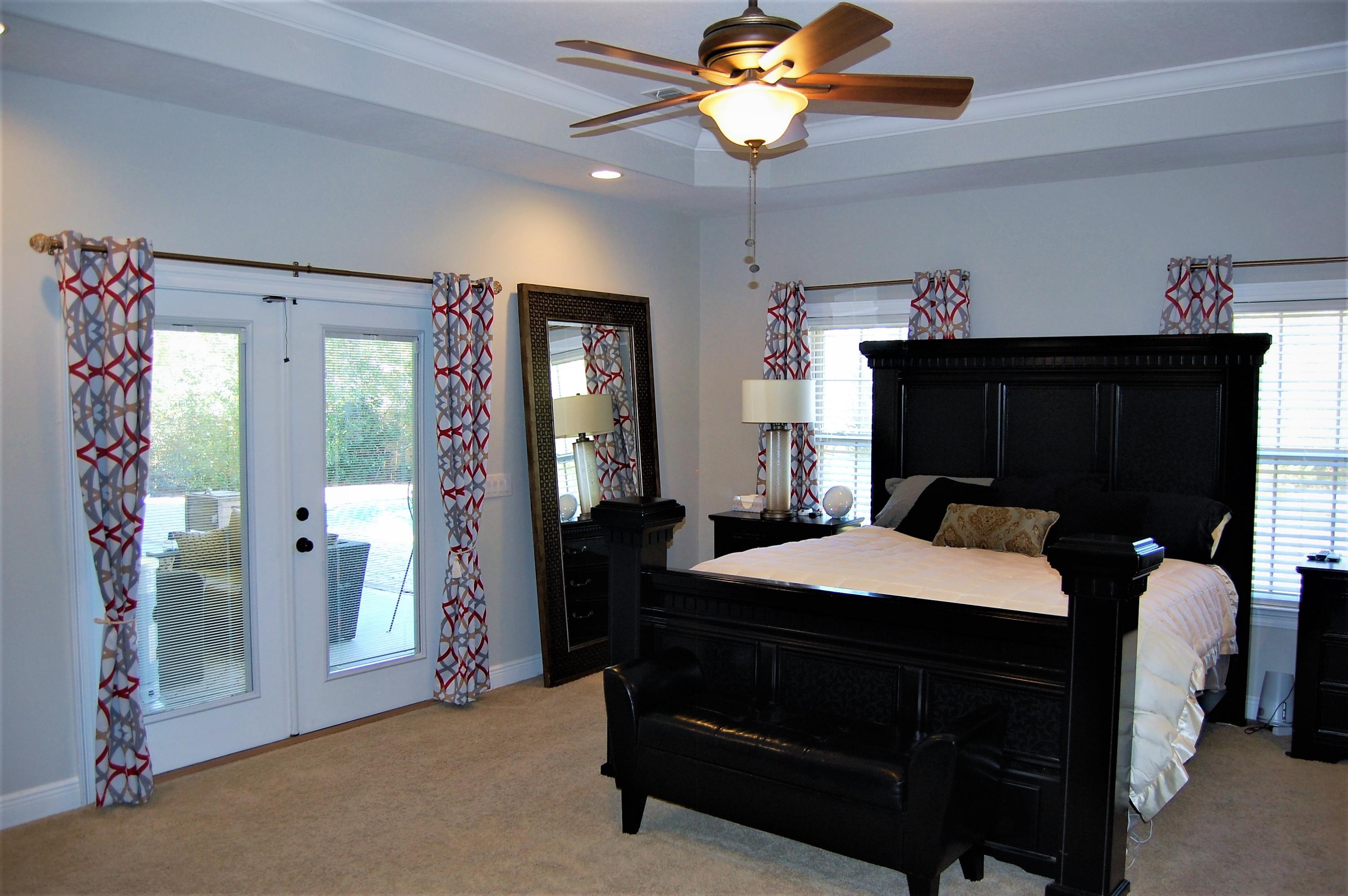 2497 Crescent Road Navarre, FL 32566 - Photo 21 of 51 a bedroom with a bed and a chandelier