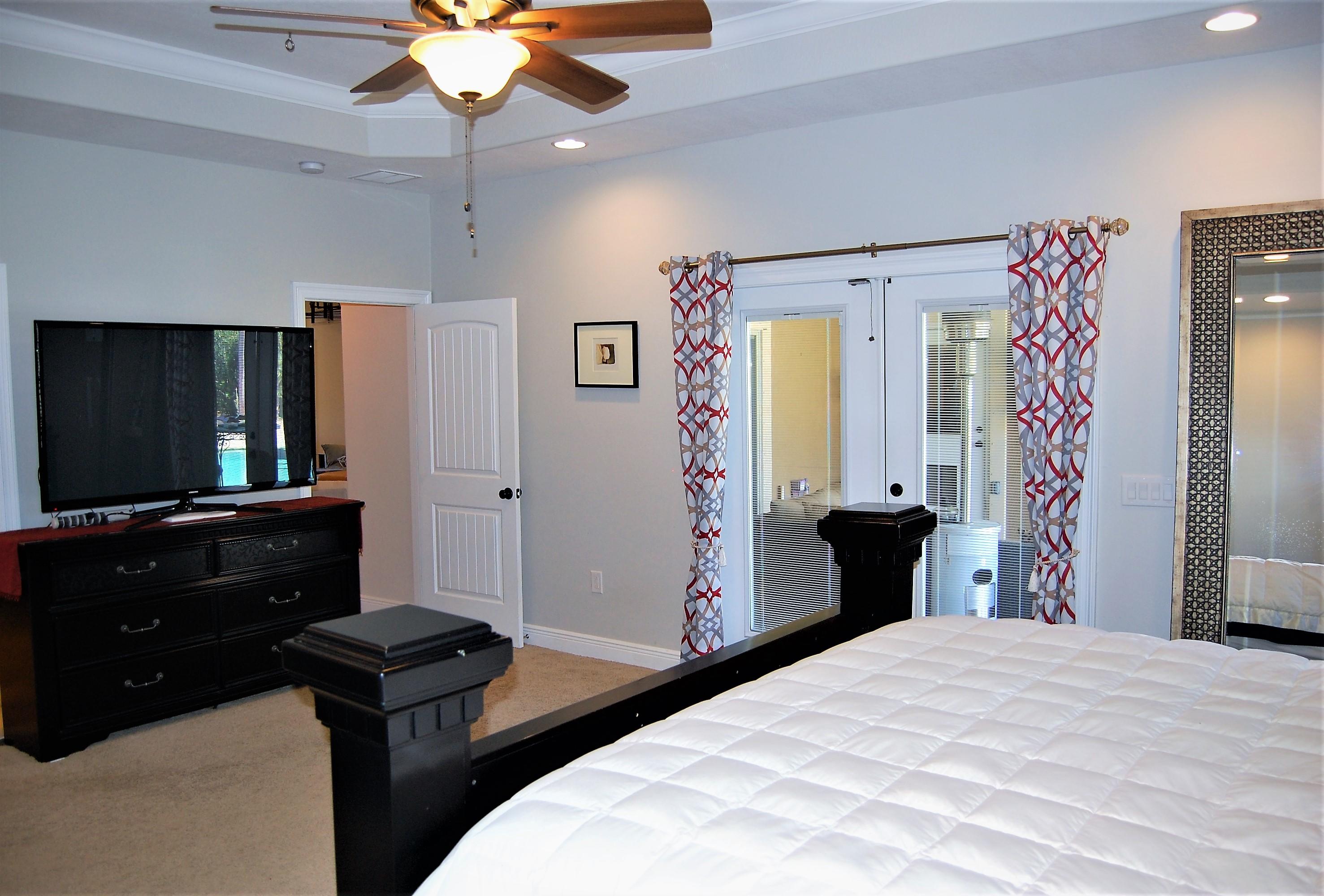2497 Crescent Road Navarre, FL 32566 - Photo 22 of 51 a bedroom with a bed and a flat screen tv