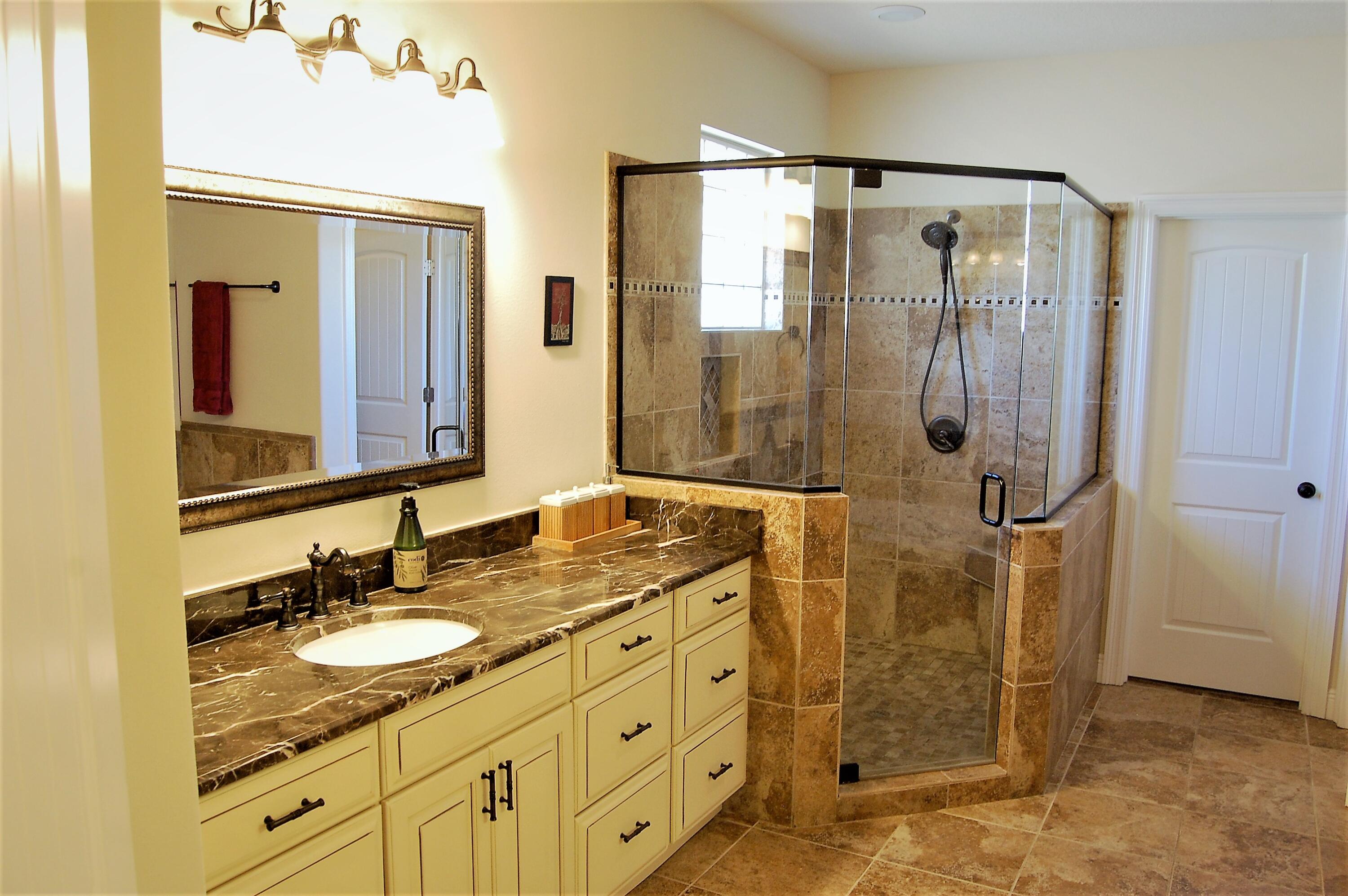 2497 Crescent Road Navarre, FL 32566 - Photo 25 of 51 a bathroom with a granite countertop sink a mirror a shower and a mirror