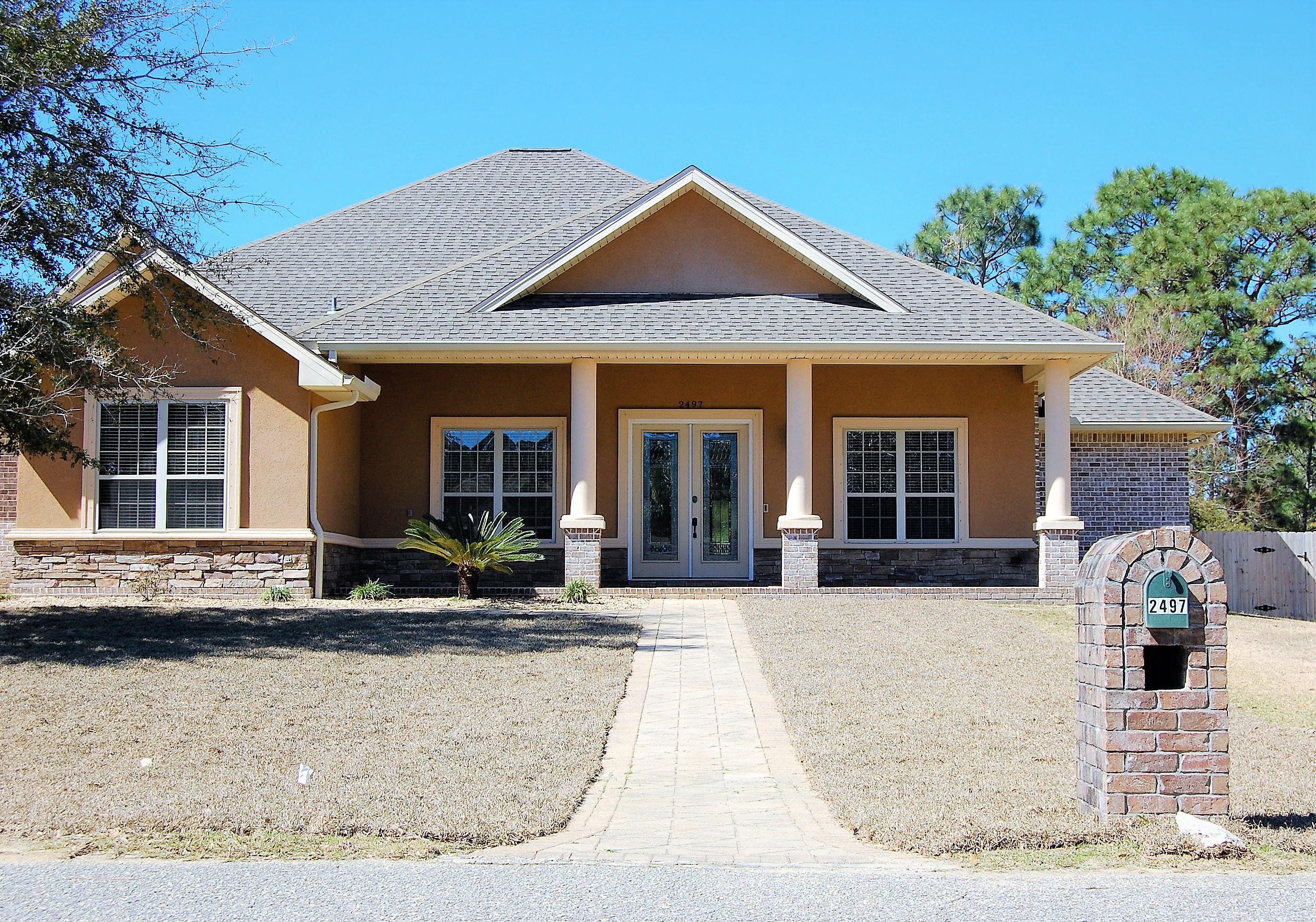 2497 Crescent Road Navarre, FL 32566 - Photo 3 of 51 a front view of a house with garden