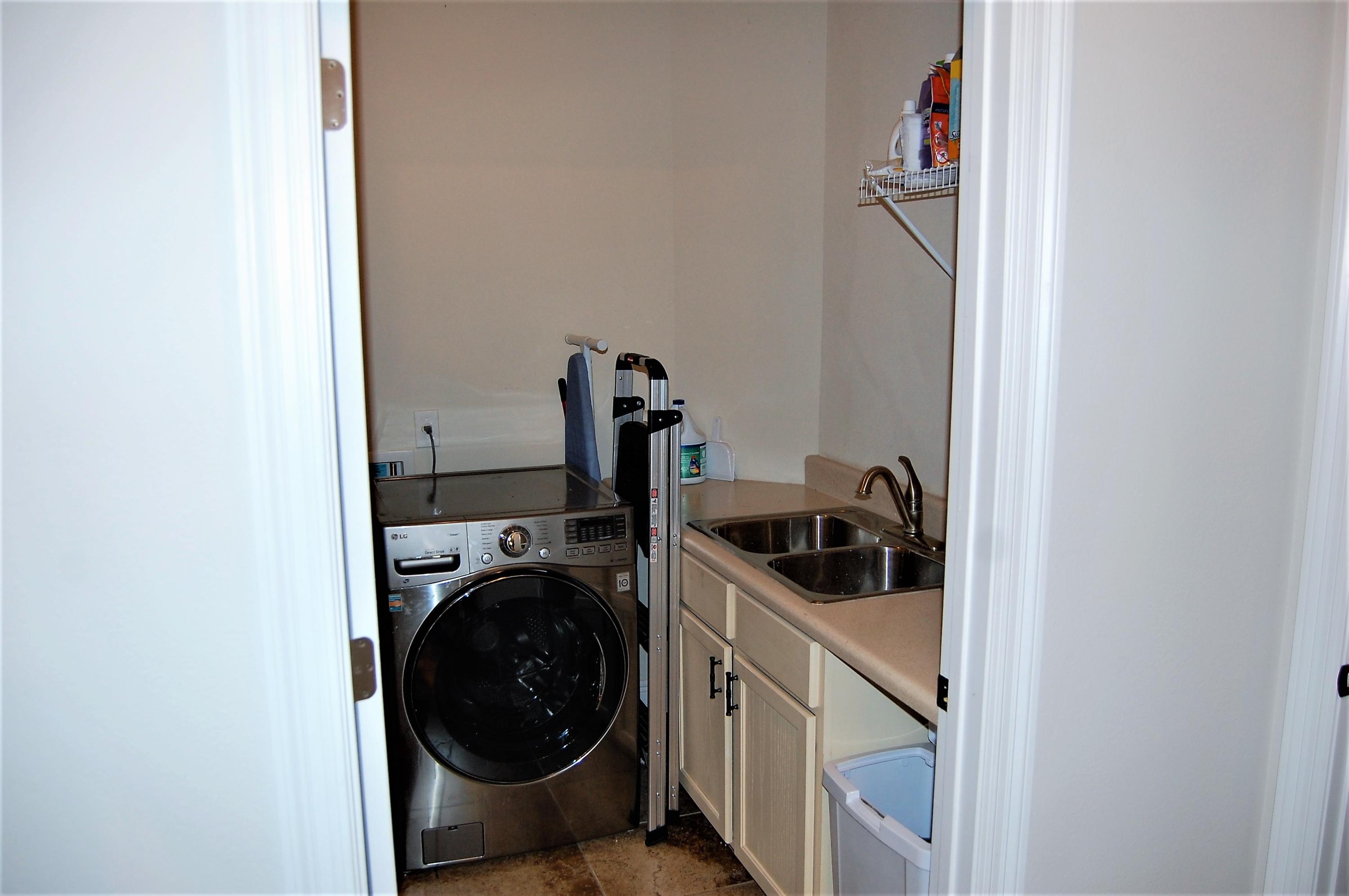 2497 Crescent Road Navarre, FL 32566 - Photo 36 of 51 a view of a storage and utility room with a washer and dryer