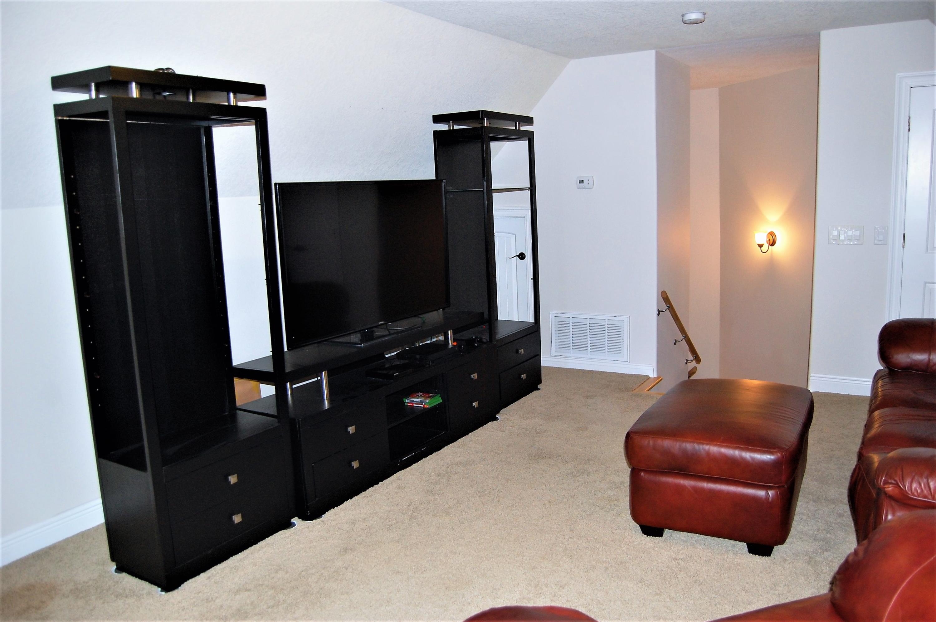 2497 Crescent Road Navarre, FL 32566 - Photo 39 of 51 a living room with furniture and a flat screen tv