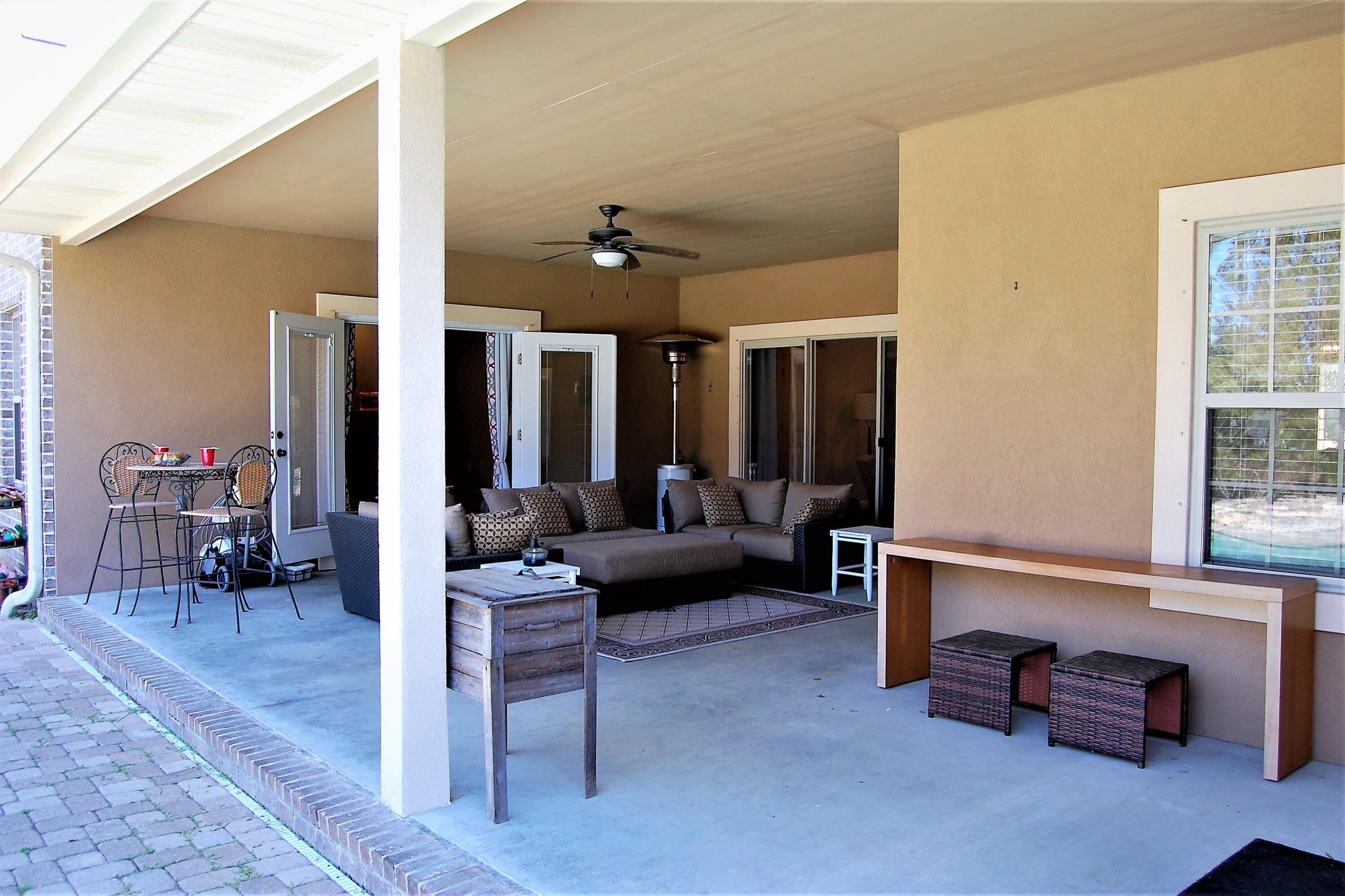 2497 Crescent Road Navarre, FL 32566 - Photo 42 of 51 a living room with furniture and a potted plant