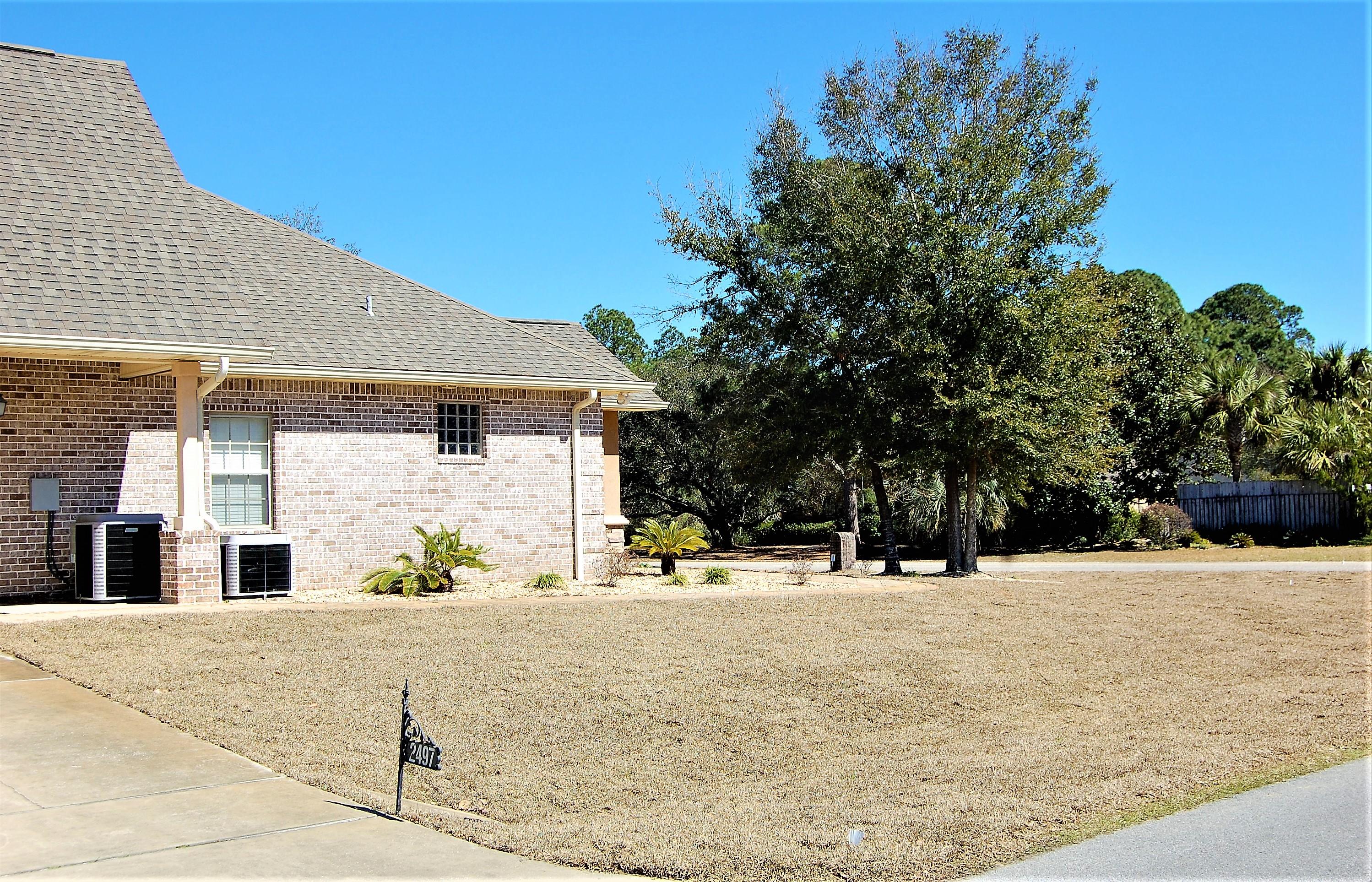 2497 Crescent Road Navarre, FL 32566 - Photo 5 of 51 a view of a white house with a outdoor space