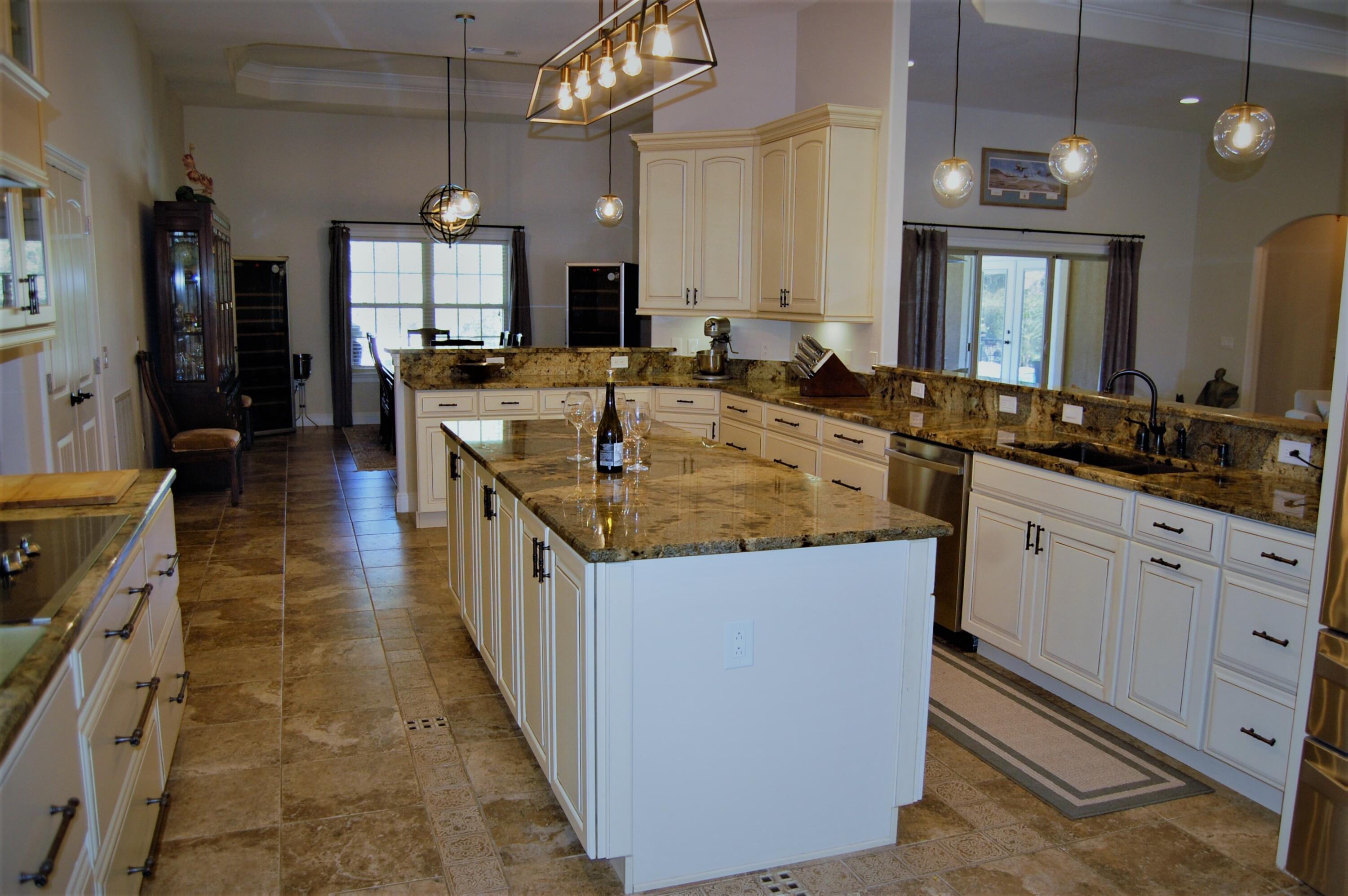 2497 Crescent Road Navarre, FL 32566 - Photo 7 of 51 a large kitchen with kitchen island a sink appliances and cabinets