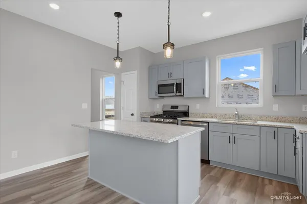 a kitchen with appliances cabinets and a sink