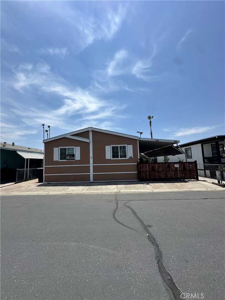 3825 Crestmore Road, Unit 414 Riverside, CA 92509 - Photo 1 of 31 a front view of a house with yard and garage