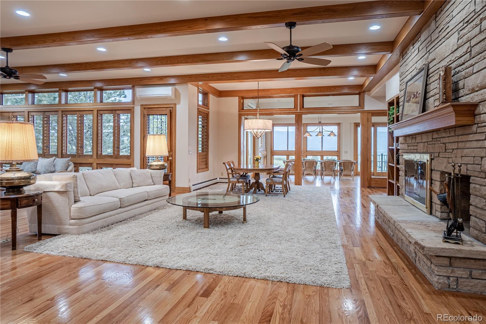 3282 Tomah Road Larkspur, CO 80118 - Photo 20 of 35 a living room with furniture a fireplace and a table