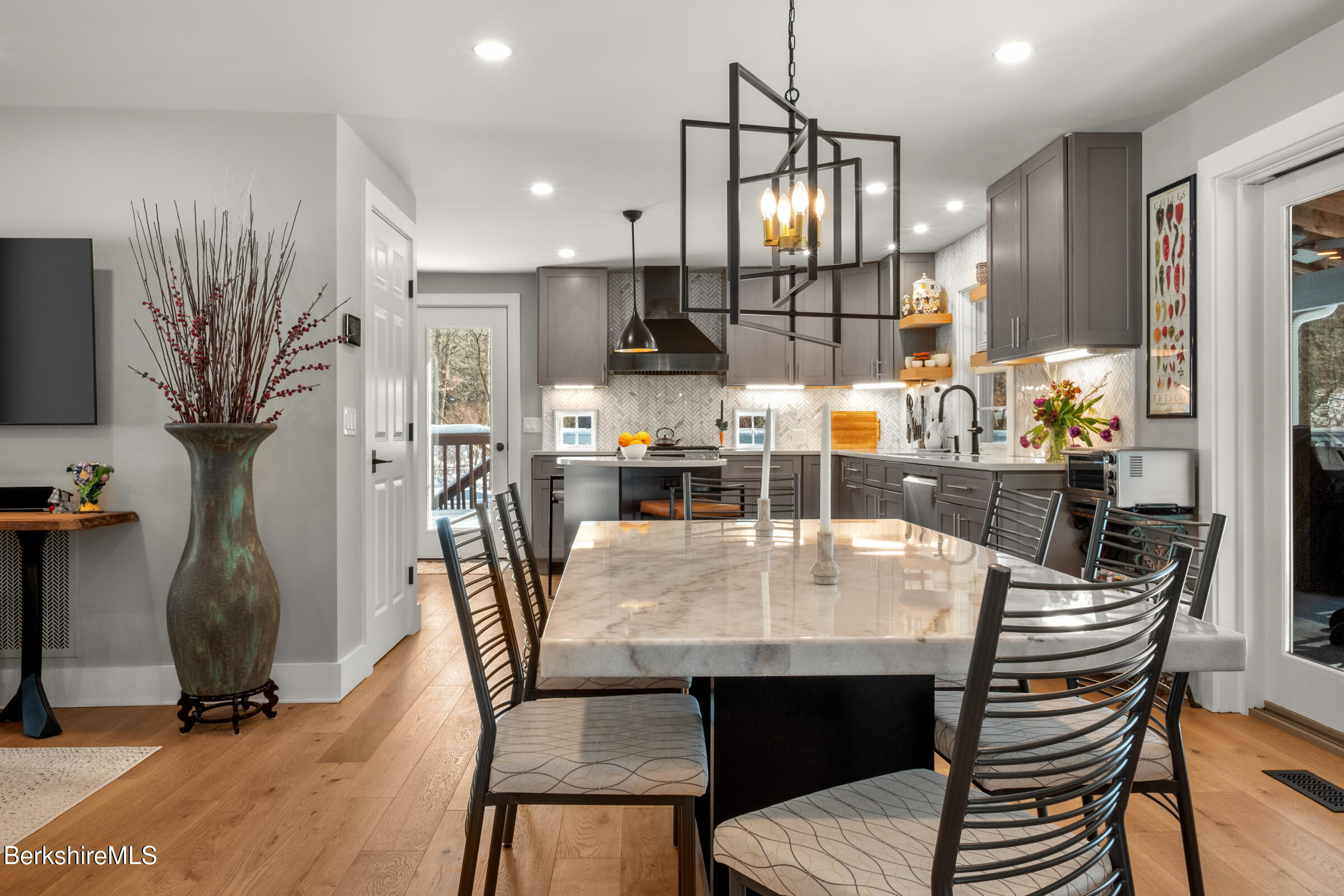 594 Shunpike Road Sheffield, MA 01222 - Photo 11 of 52 a kitchen with stainless steel appliances kitchen island granite countertop a dining table chairs and a refrigerator