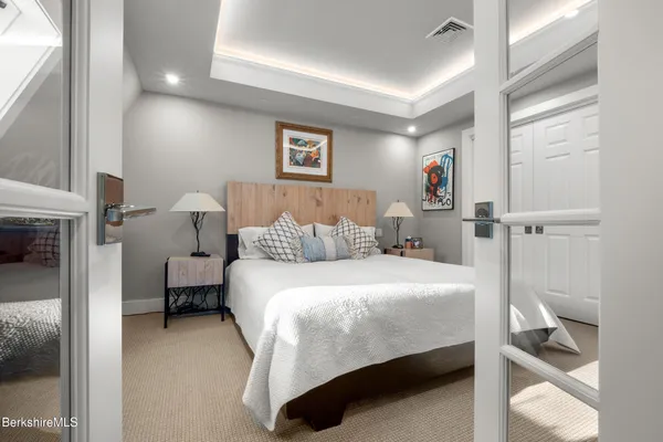 a bedroom with a bed and a flat screen tv