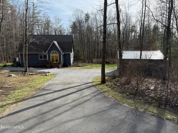 a bedroom with a large bed and a flat screen tv