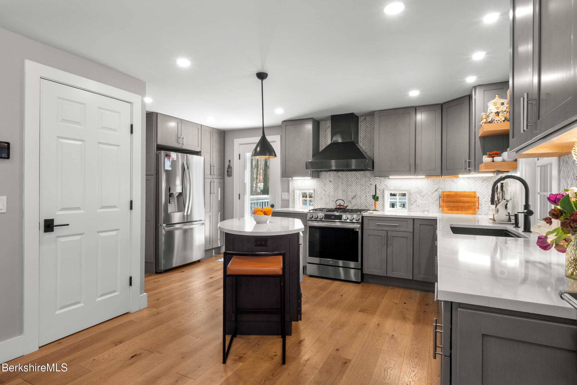 594 Shunpike Road Sheffield, MA 01222 - Photo 24 of 52 a kitchen with stainless steel appliances granite countertop a refrigerator a sink dishwasher a stove and white cabinets with wooden floor