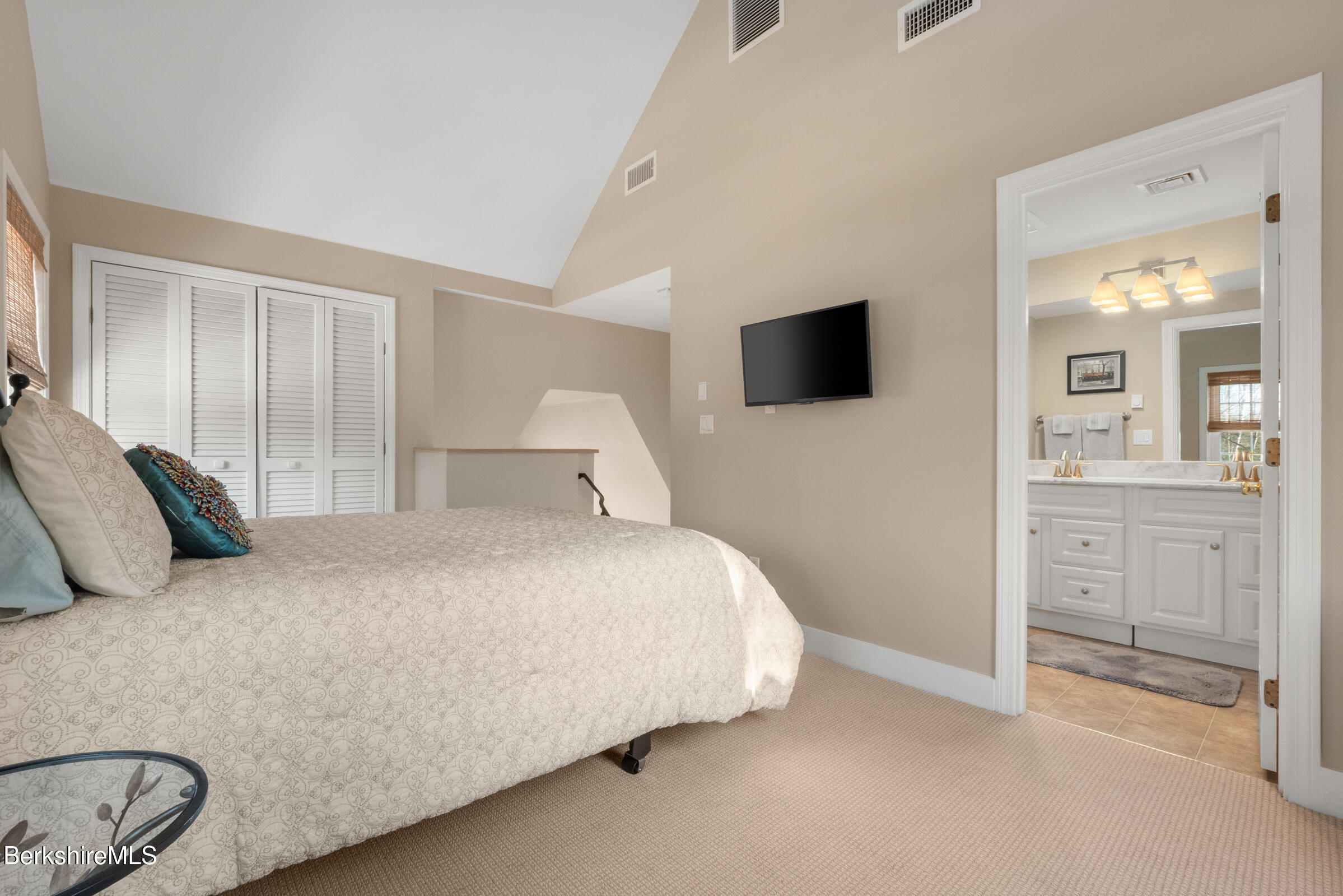 594 Shunpike Road Sheffield, MA 01222 - Photo 32 of 52 a bedroom with a bed and a flat screen tv