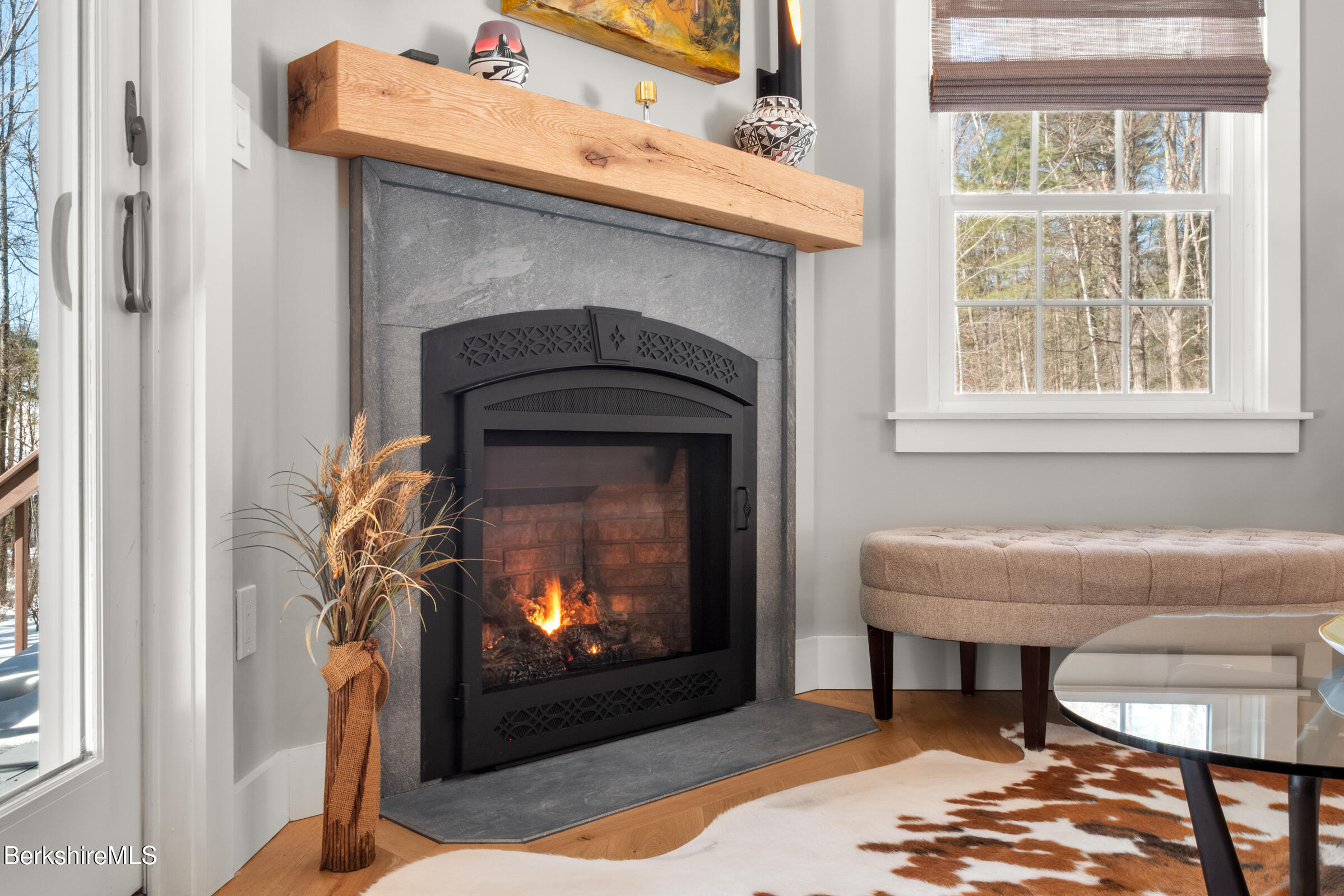 594 Shunpike Road Sheffield, MA 01222 - Photo 43 of 52 a living room with a fireplace and a window