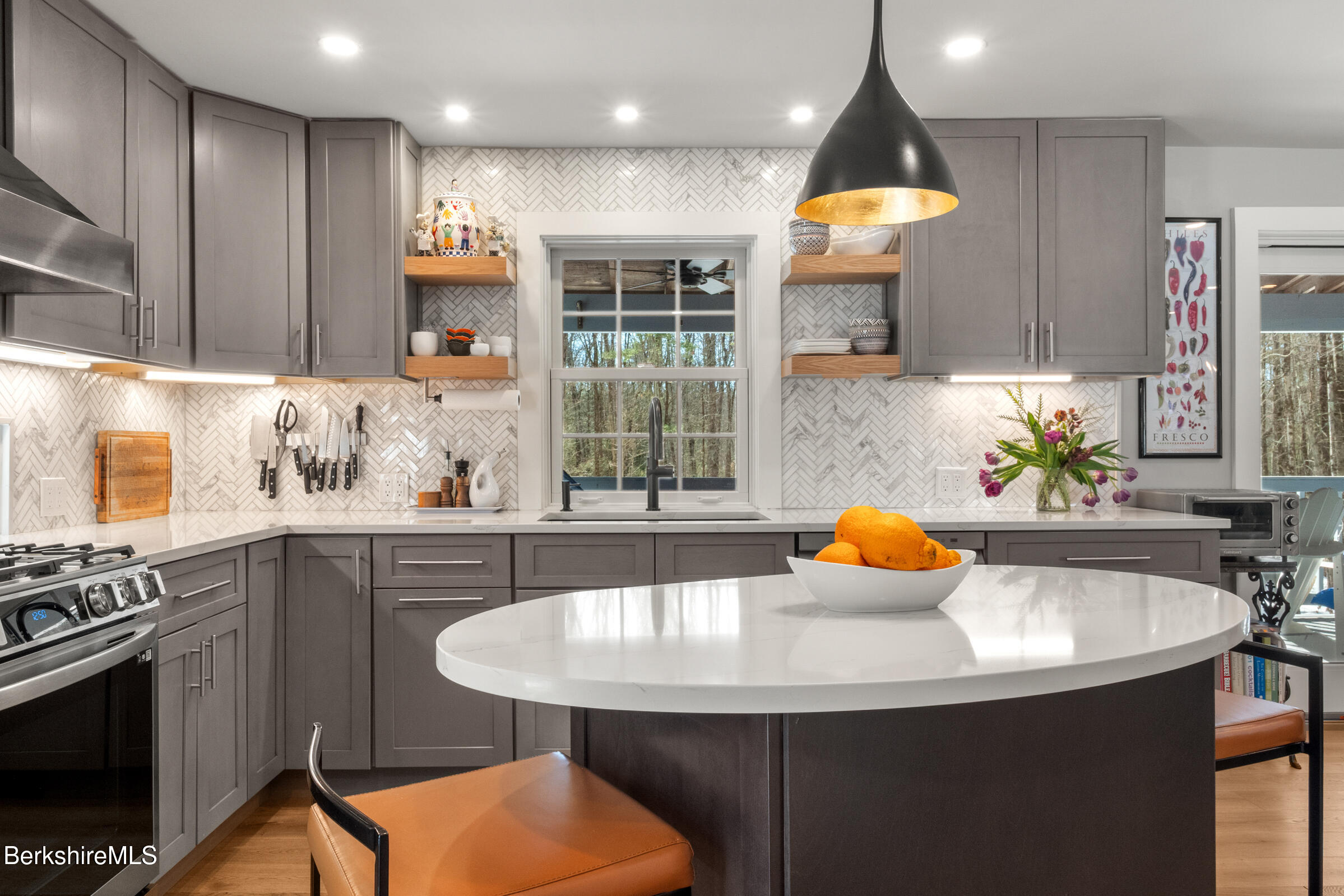 594 Shunpike Road Sheffield, MA 01222 - Photo 46 of 52 a kitchen with a sink a stove a kitchen island with chairs and cabinets
