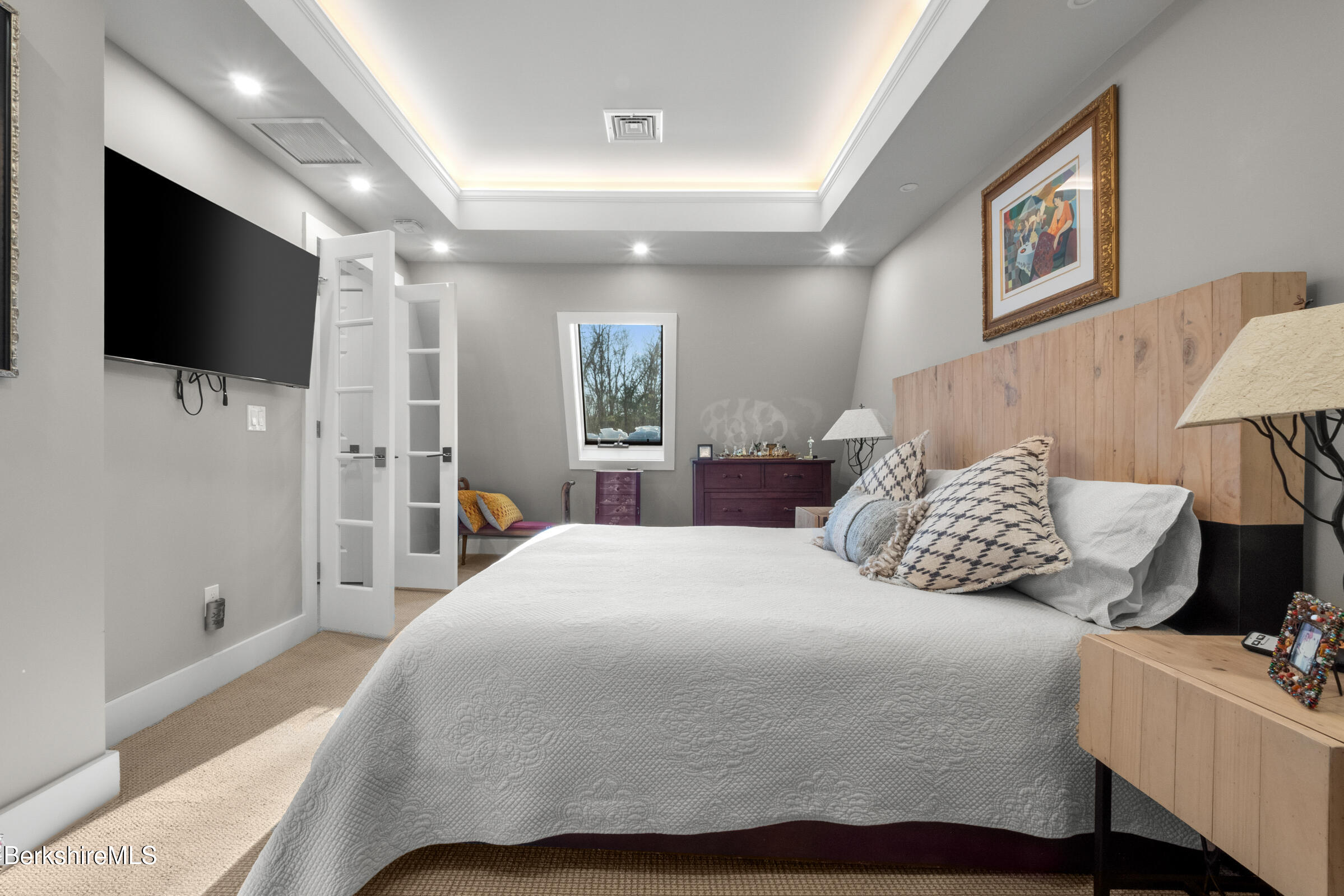 594 Shunpike Road Sheffield, MA 01222 - Photo 5 of 52 a bedroom with a large bed and a flat screen tv