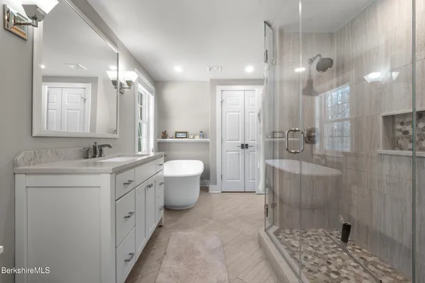 a bathroom with a double vanity sink and a mirror