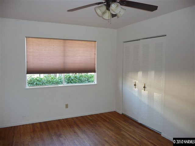 3090 Slater Avenue Reno, NV 89503 - Photo 7 of 9 an empty room with wooden floor and windows