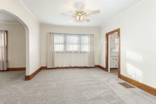 an empty room with windows and closet