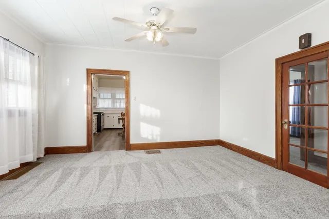 a view of empty room with a ceiling fan and window