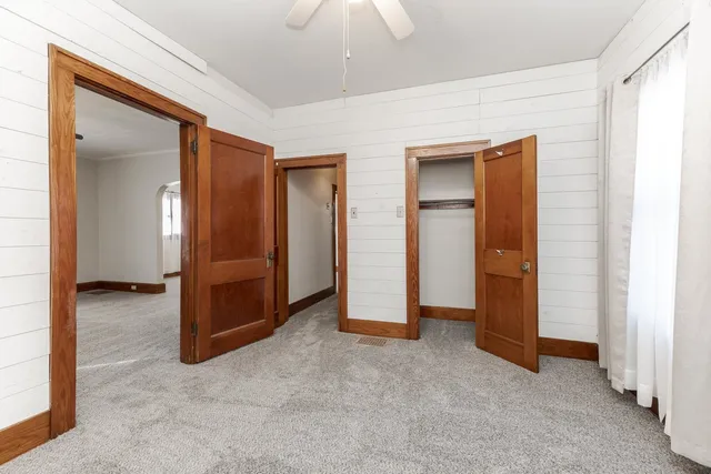 an empty room with closet and a bathroom