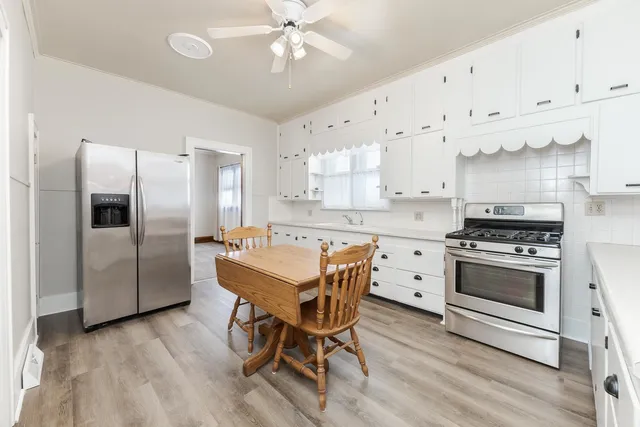 a kitchen with granite countertop a sink a counter space stainless steel appliances and cabinets