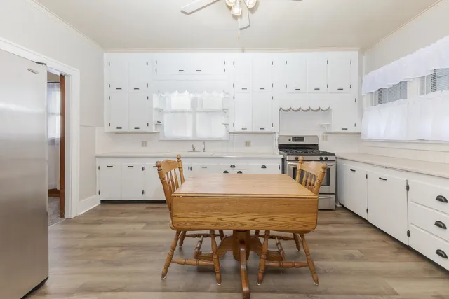 a large kitchen with a table and chairs in it