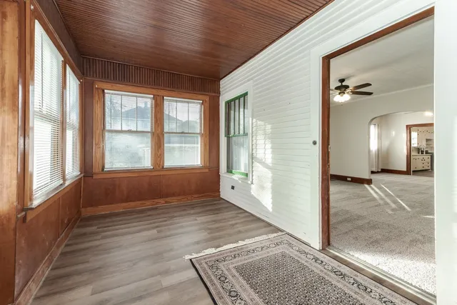 a view of an entryway with wooden floor and windows