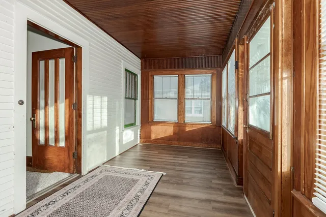 a big room with wooden floor and windows