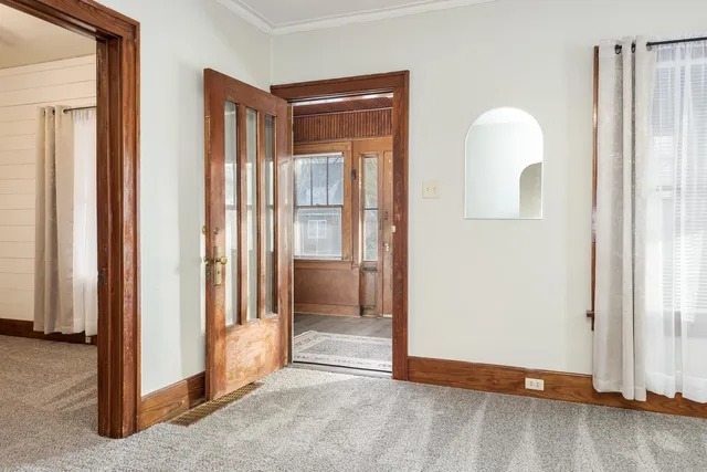 a view of empty room with wooden floor and cabinet