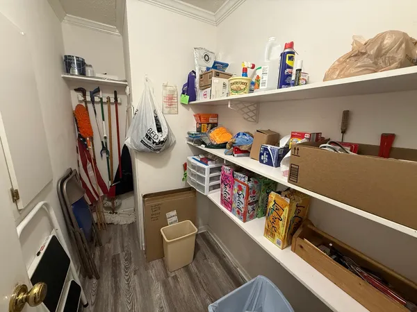 a kitchen with kitchen island a counter space a stove a refrigerator and cabinets