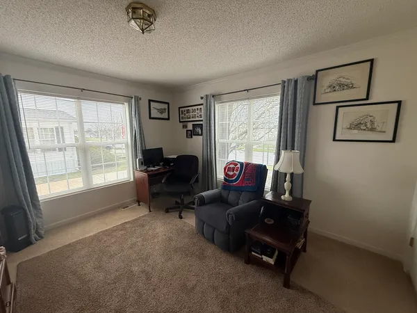 a living room with furniture gym equipment and a large window