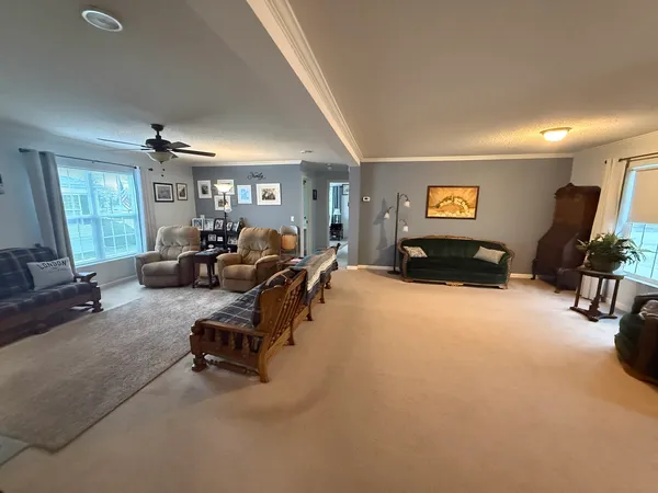 a living room with furniture a mirror and a window