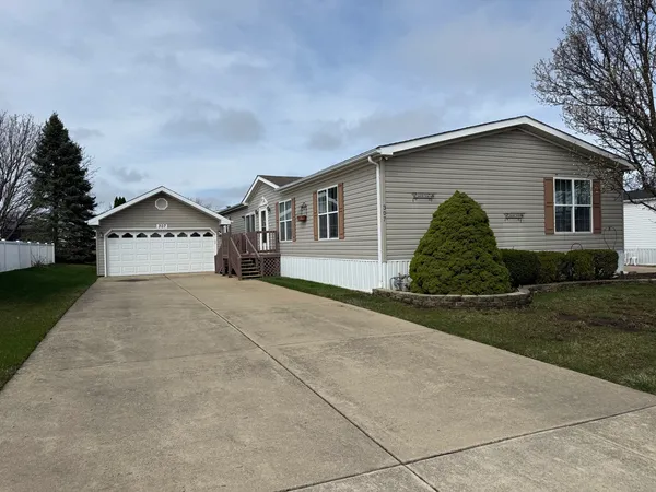 a view of a house with wooden fence