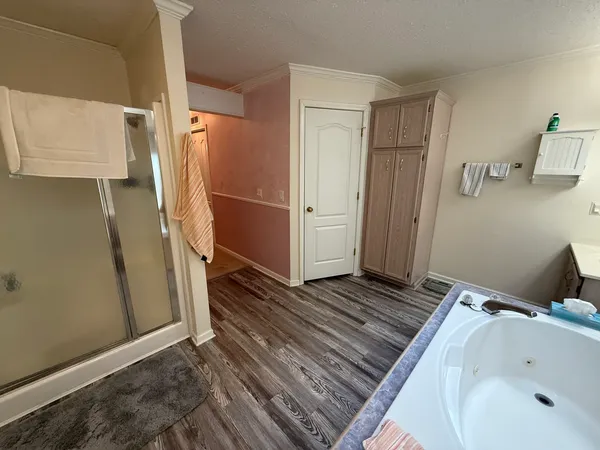 a room with a bed a mirror and furniture