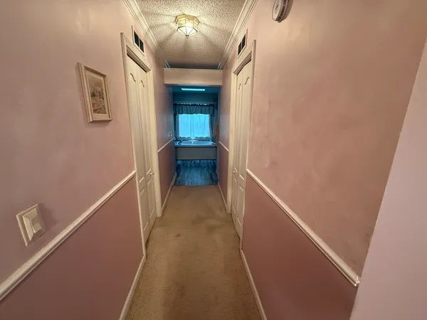 a bedroom with a bed dresser and a flat tv screen