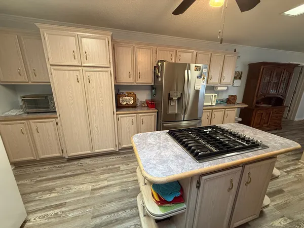 a kitchen with sink refrigerator and stove