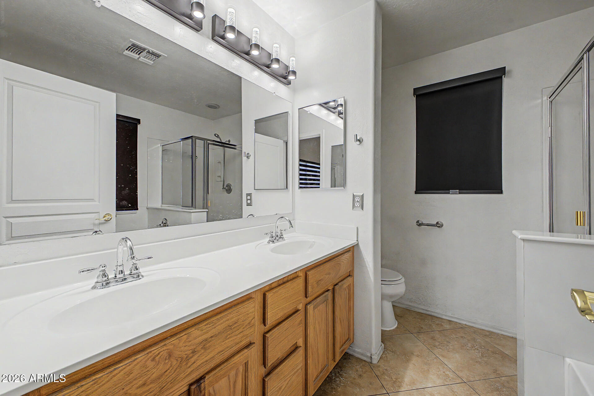 2340 West Apollo Road Phoenix, AZ 85041 - Photo 13 of 26 a bathroom with a sink and a mirror