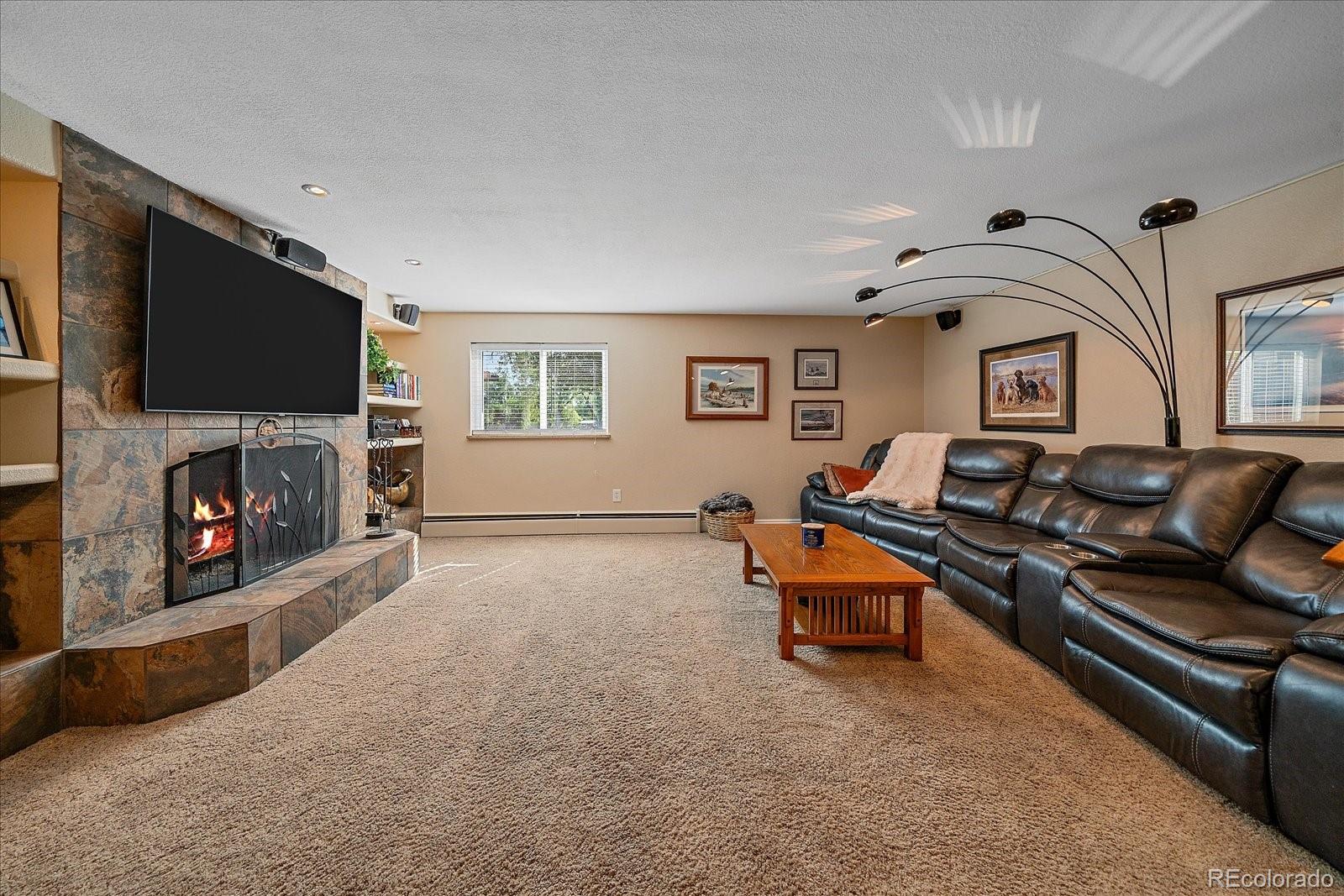 930 Reed Court Lakewood, CO 80214 - Photo 19 of 41 a living room with furniture and a fireplace