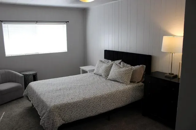 a bedroom with bed and window