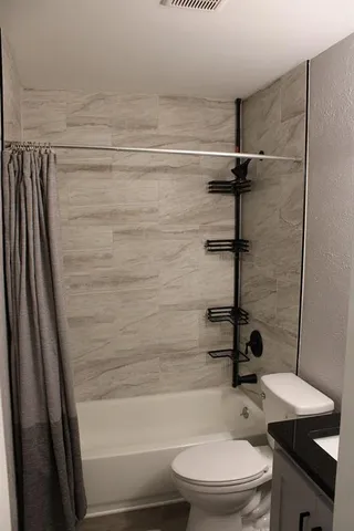 a bathroom with a toilet a sink and a shower