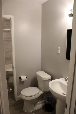 a white toilet sitting next to a bathroom sink