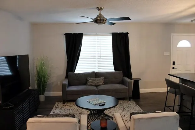 a living room with furniture and a flat screen tv