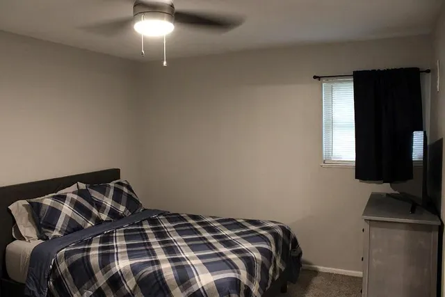 a bedroom with a bed and a television