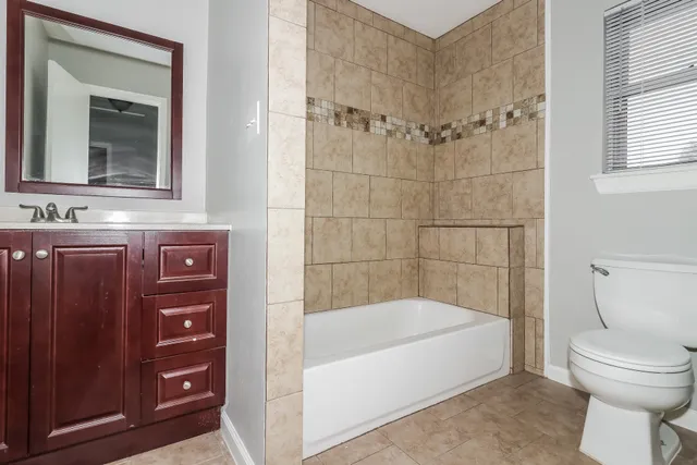 a bathroom with a bathtub and a toilet