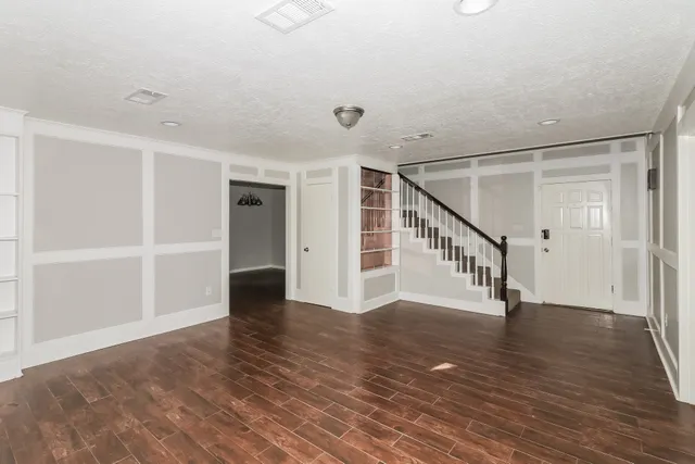 a view of an entryway with wooden floor